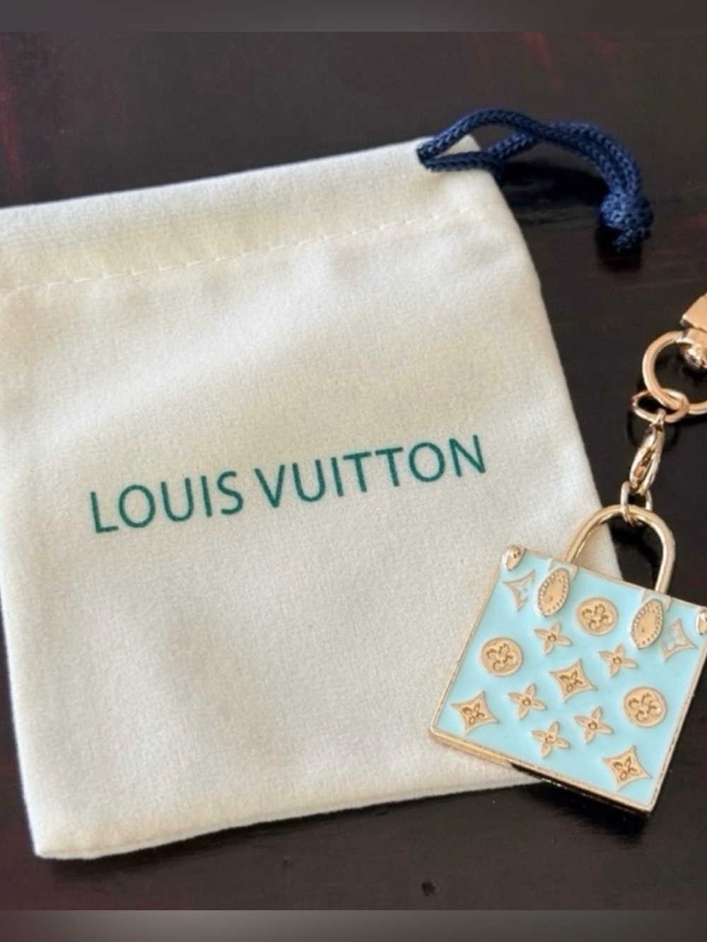 Louis Vuitton stamped Mini Bag
Charm/Keychain/ Tiffany
Blue & Gold 3" long EUC